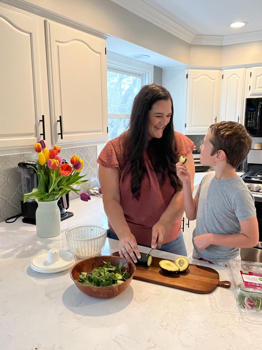 Alyssa cutting vegetables with child