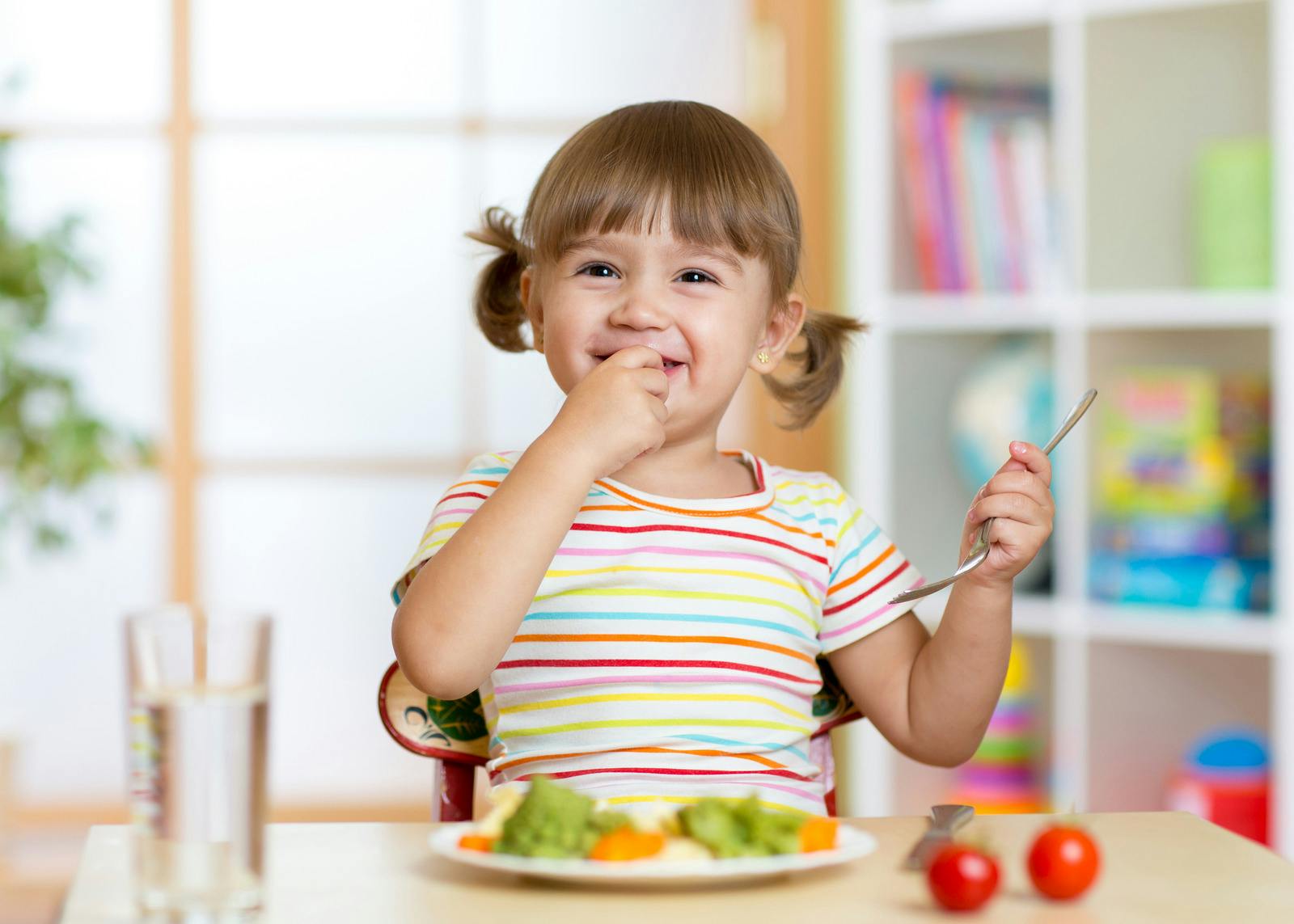 Child smiling while eating food