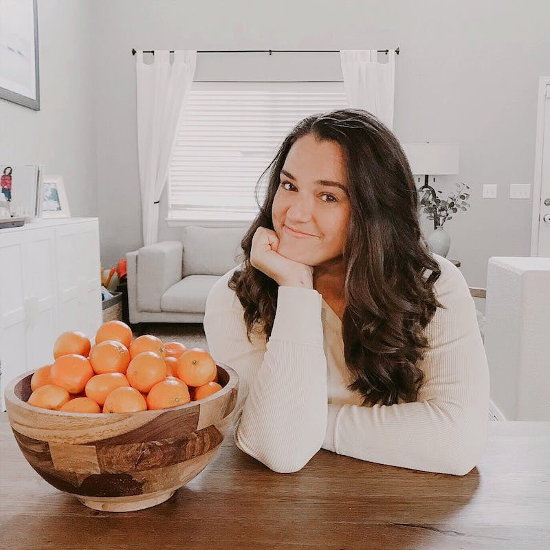 Alyssa at a table with oranges